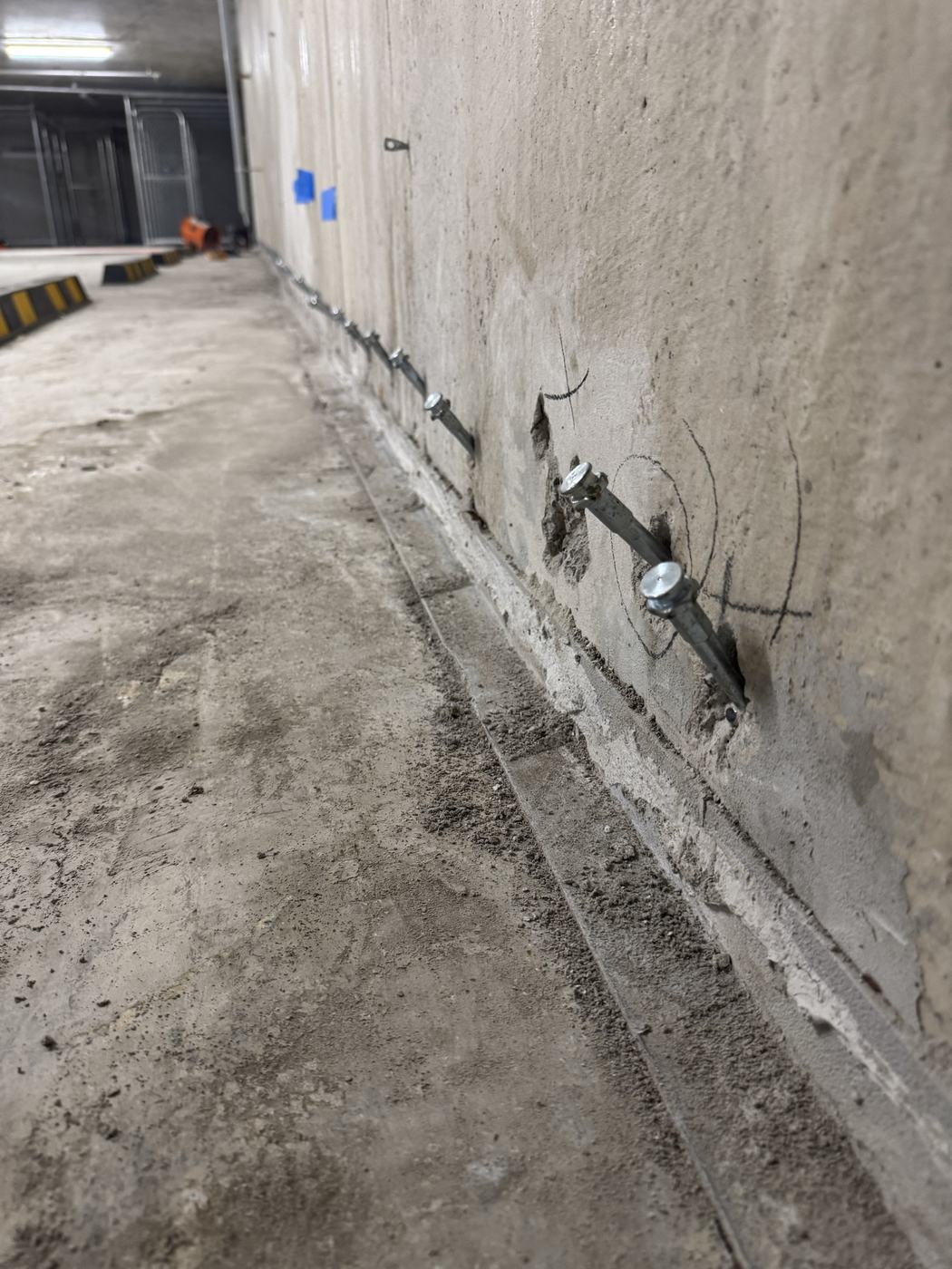 Injection packers installed in a row along the wall-to-floor construction joint of a basement carpark
